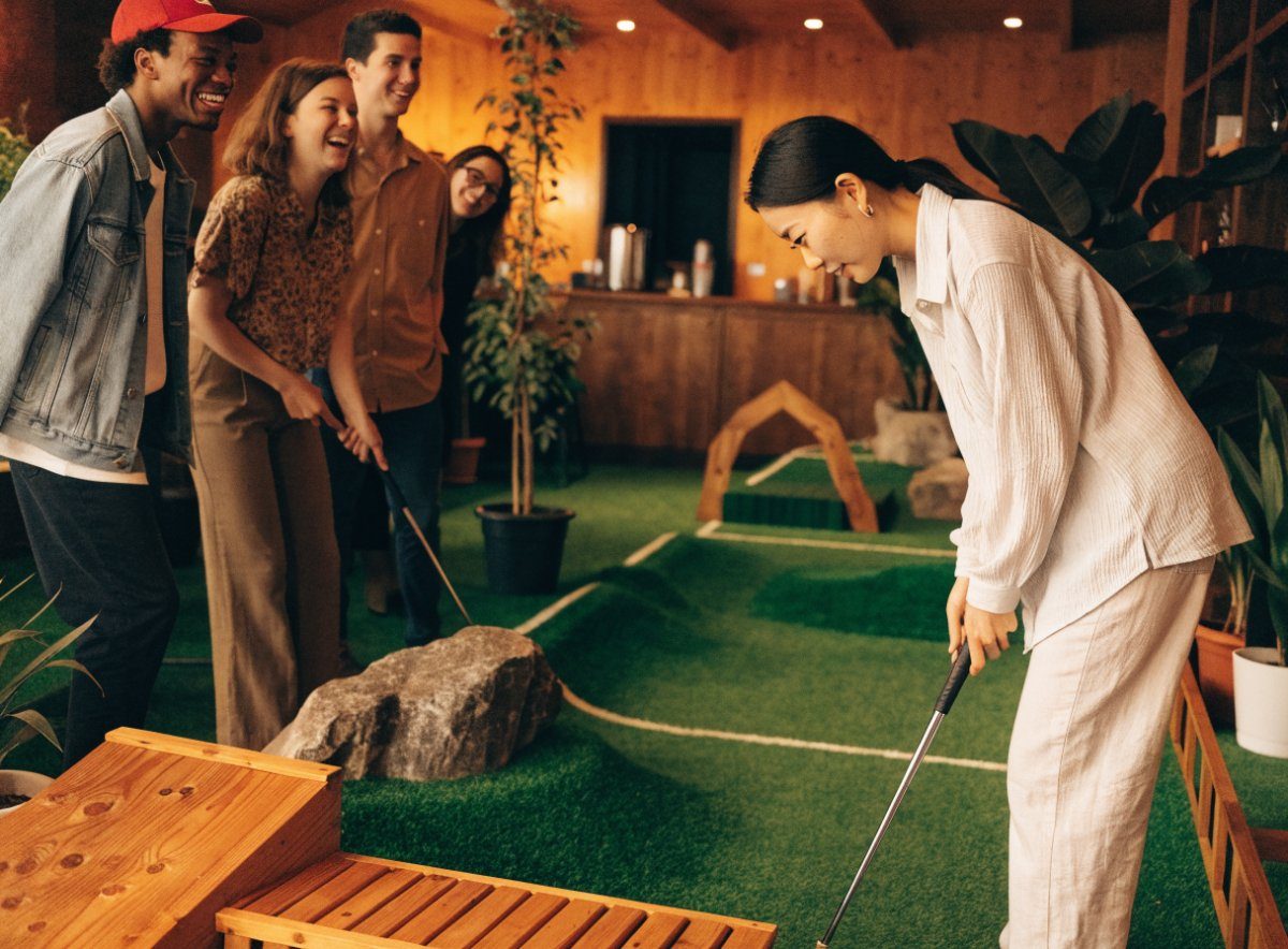 Friends playing mini golf